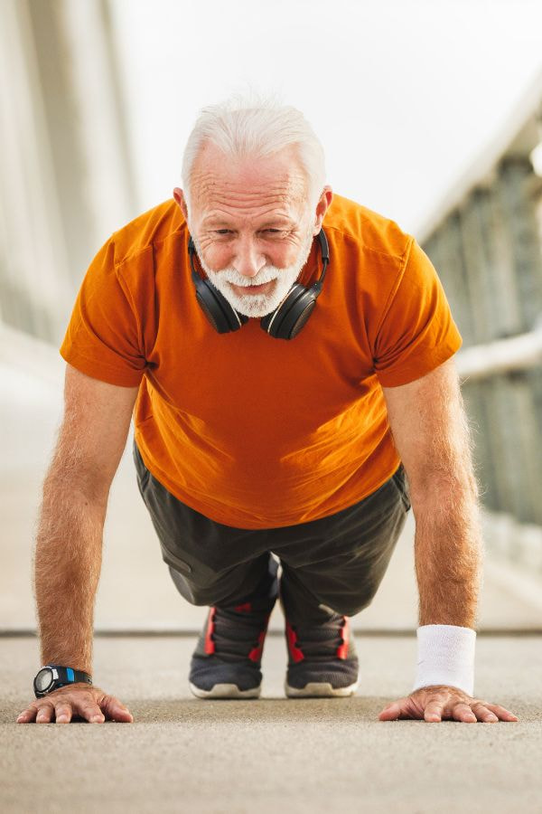 image of an elderly man completing a push-up