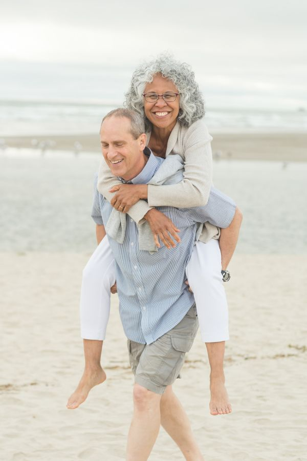 image of a fit middle-aged couple enjoying the beach together