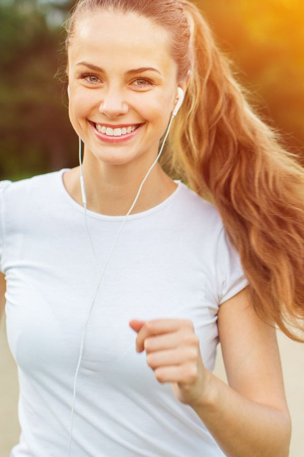 image of a woman smiling while running