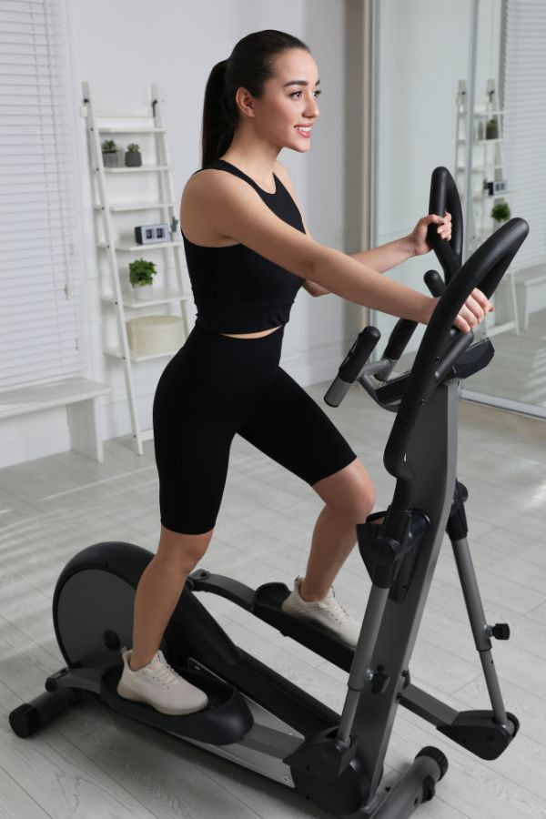 image of a fit woman enjoying an elliptical machine