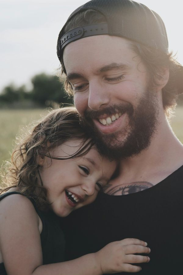 image of a father and daughter holding each other and smiling