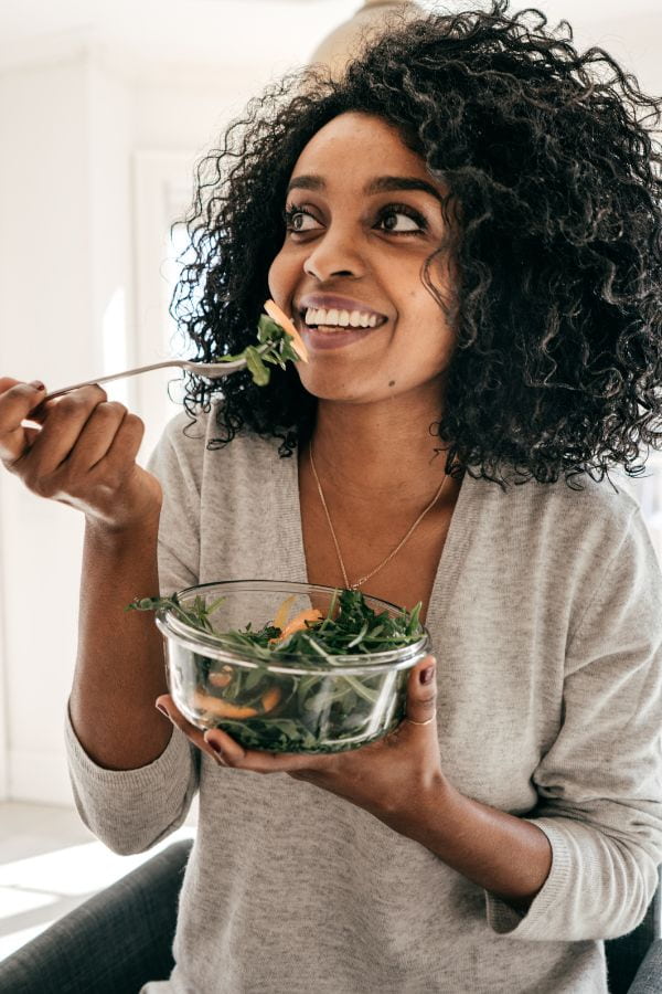 image of a woman enjoying a salad